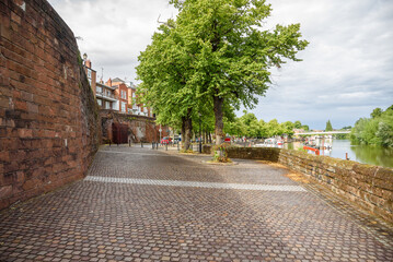 Riverbank park along the old city walls in Chester on a cloudy summer day