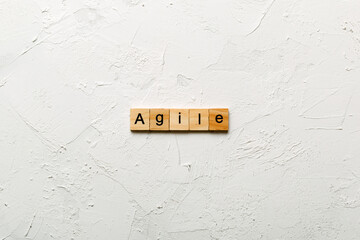 Agile word written on wood block. Agile text on cement table for your desing, concept