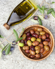 organic olive oil and olives on the table