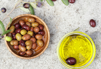 organic olive oil and olives on the table