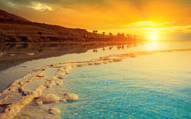 Seascape in the morning. Orange sunrise over the Dead Sea