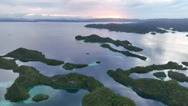 Daybreak illuminates the beautiful limestone islands of Pef in Raja Ampat, Indonesia. This remote, tropical region is known to harbor the world's greatest marine biodiversity.