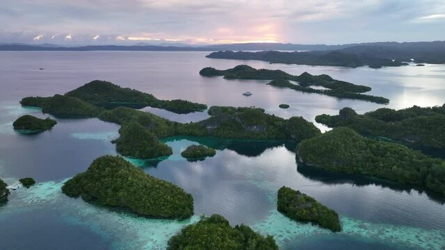 Daybreak illuminates the beautiful limestone islands of Pef in Raja Ampat, Indonesia. This remote, tropical region is known to harbor the world's greatest marine biodiversity.