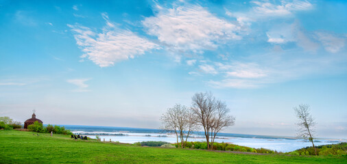 Panoramic photo of the steep banks of the Dnieper River and an old church on a cliff. Ukraine. Dnieper steeps.
