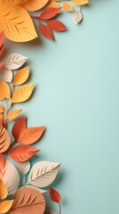 Autumn leaves paper art border on a teal background with copy space. Creative fall season design concept for invitations, posters, and stationery.

