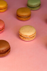 Colorful macarons on pink background. Selective focus.