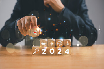 Start 2024 plan concept. Businessman show target icon action, target business trend strategy. Goal...