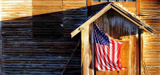 Old American Flag on Weathered Building Door - 795476588