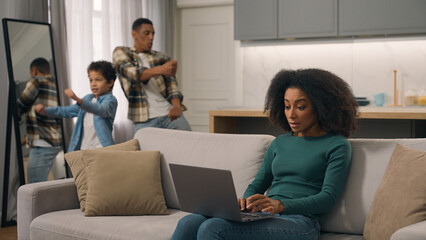Quarantine family problems African American woman female mom trying to work online laptop pc sit...
