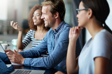 Business people, laptop and meeting in office for conversation, planning and teamwork. Colleagues, diversity and boardroom together with technology for communication, research and collaboration