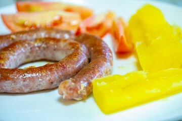 Traditional rustic Brazilian food, sausage with cassava and tomatoes