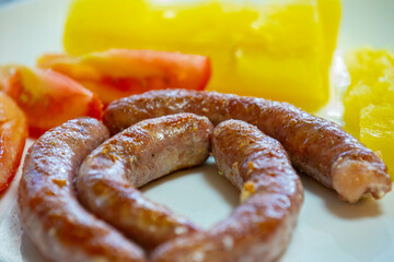 Traditional rustic Brazilian food, sausage with cassava and tomatoes