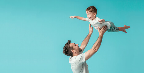 Happy Father Days Image of a Father and Son Playing on a Blue Background with Space for Copy