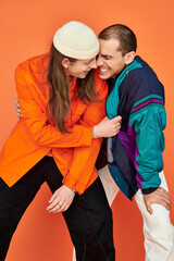 Two men, a loving gay couple, embrace each other tightly in a warm hug.