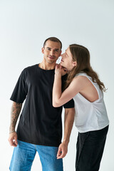 A loving gay couple, two men, standing together with arms around each other.