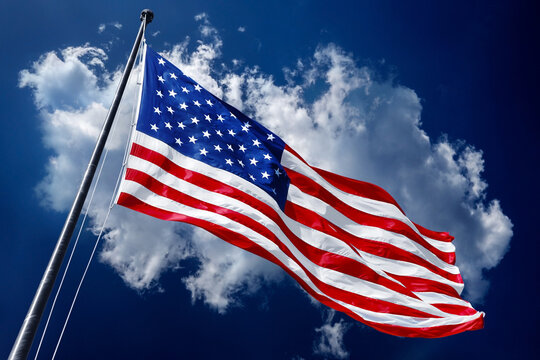 American flag on blue sky with beautiful clouds