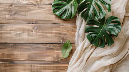 Green monstera leaves  on wooden table