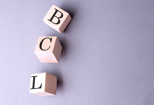 BPS word on wooden block on gray background