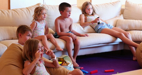 Children at living room sofa in front of TV play room kids and friends together