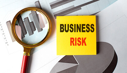 BUSINESS RISK text on sticky on chart background