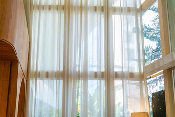 Backlit window with white curtains in empty Modern room,white waving curtain in bedroom..