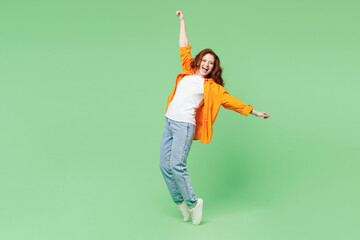 Full body young ginger fun woman she wear orange shirt white t-shirt casual clothes stand on toes...