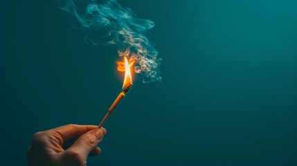   A hand holds a lit match against a dark blue backdrop, smoke ascending from its tip