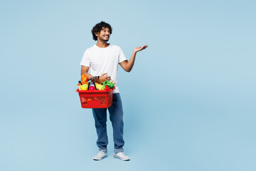 Young happy Indian man wear white t-shirt casual clothes hold red basket for takeaway mock up with...
