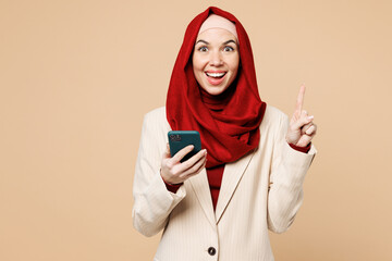 Young Arabian Asian Muslim woman wear red abaya hijab suit clothes hold use mobile cell phone point...