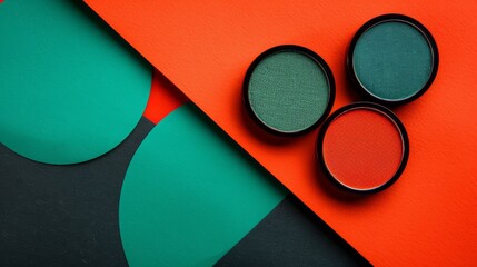   A pair of eyeshades sits atop an orange-green background; beside it rests another pair, green in color