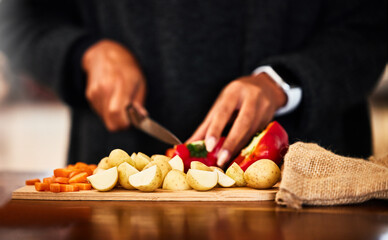 Hands, vegetables and knife on board for prepare in home with raw ingredients with kitchen chef, food and health. Cooking, dinner and person for lunch with eating for nutrition with organic diet