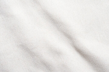 A soft, pure white fabric background with a delicate grid pattern. The texture is smooth and plain, resembling linen or cotton. Light creates subtle shadows on the surface.