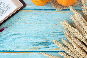 Ripe wheat, open holy bible book, and autumn fruit on wooden background. Top table view. Copy...