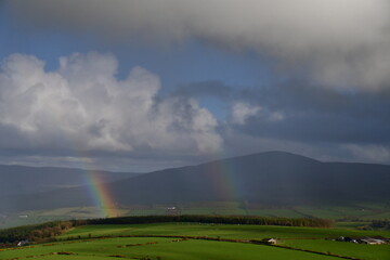 Naklejka na ściany i meble View of rainbow over tne mountains. Coppanagh Hill, Co. Kilkenny, Ireland