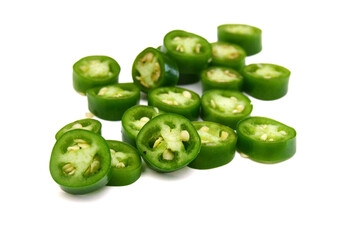 Fresh green cut chili pepper pieces on a white background