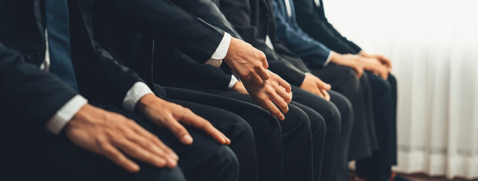 Group of interviewee candidate in formal suit line up for interview sitting on the chair. Job opportunity recruitment for HR agency and vacancy concept. Shrewd