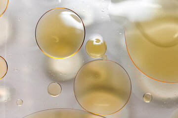Close-up of oil droplets floating on water.