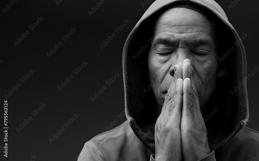 Poster praying to god with hands together on dark background stock photo - Posters