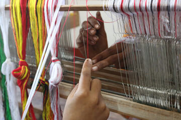 Handloom weaver in India working in her loom