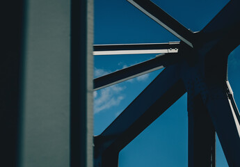 A fragment of the steel structure of the railroad bridge against the sky.  - 795568574