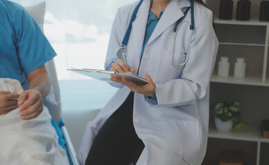 Young doctor is using a stethoscope listen to the heartbeat of the patient. Shot of a female doctor...