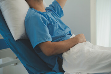 Fototapeta premium Seriously Ill Man Lying on a Bed in the Hospital. Monitors Show His Vital Signs. Ward is Clean and New.