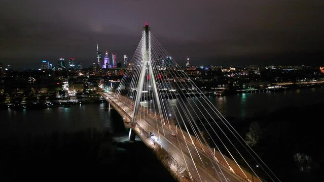 Swietokrzyski Bridge over the Vistula River with a panoramic view of the center of Warsaw at night. Poland