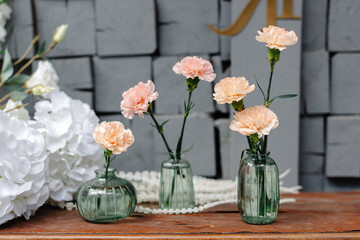 Three vases with flowers on a table