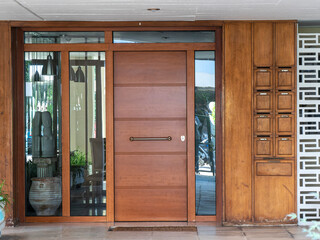 A contemporary design apartment building entrance with a wooden door. Travel to Athens, Greece.
