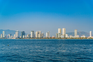Fototapeta na wymiar The city is from a distance from the sea. Nha Trang city in Vietnam. View of the city from the sea.