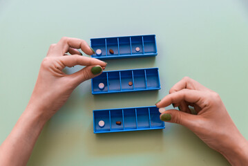 Organizing Medication with Weekly Pill Boxes.