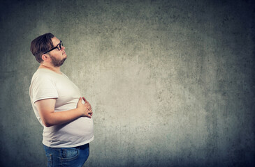 man feeling bloated with arms on belly