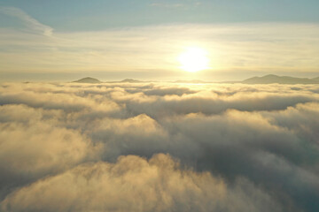 Aerial view of beautiful mountains above clouds