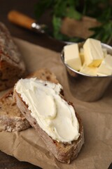 Tasty bread with butter on table, closeup